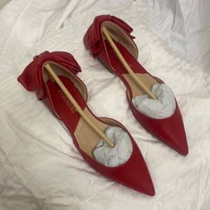 Cute, red, pointy flats with a big bow on the back